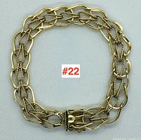 Bracelet arranged in circular shape showing overall design and closure area.