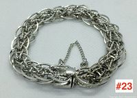 Front view of sterling silver bracelet showing complex link design and safety clasp