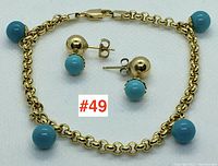 Bracelet and earrings laid flat on white background, centered