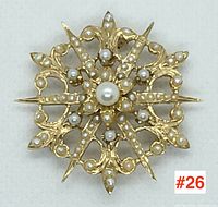 Front view of starburst brooch pendant showing central pearl and surrounding small pearls on filigree gold