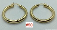 Pair of polished 14k yellow gold hoop earrings showing full front view side-by-side on white background.