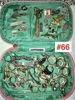 Top-down view of open jewelry case showing all compartments and most contents