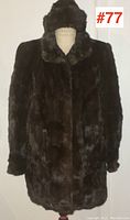 Front view of the dark brown ladies short mink coat on a dress form, showing its medium length and classic collar.