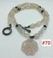 Full view of the necklace showing beads and toggle clasp laid flat.