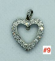 Top-down front view of heart-shaped pendant showcasing diamond-set open design