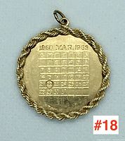 Front view of circular pendant showing calendar engraving and rope border