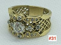 Front view of ring showing central diamond and accent stones