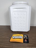 Front view of the white plastic Gamma Vittles Vault container with embossed paw prints and attached product label.