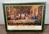 Photo of the puzzle box featuring The Last Supper puzzle image and quote from Luke 22:19-22.