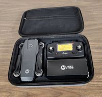 Open case showing folded Holy Stone HS720 drone and 2.4GHz remote control inside with accessory box