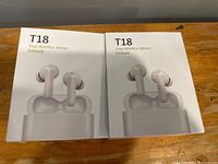 Two boxed T18 True Wireless Stereo Earbuds pairs showing front packaging with earbud picture.