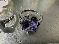 Close-up of the purple flower design aroma ring size 8 showing detailed setting and faceted stone.