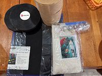 Photo showing black Velcro roll, kraft paper tape rolls, 11x14 magnetic dry erase board, paint by number kit with paints and brushes in packaging.