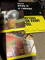 Four sealed INK Box tattoo packages with colorful printed envelopes and branding