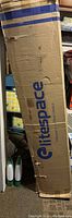 Upright cardboard box with Litespace brand printed in blue letters