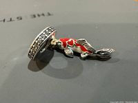 Left side view of the Pandora koi carp charm showing red and white enamel on the fish and crystal-studded bail.