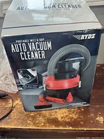 Image of the retail box showing RYDZ Portable Wet & Dry Auto Vacuum Cleaner with a flexible hose and attachments depicted.