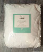 Folded and packaged Home Suite Luxury Solid Rabbit Faux Fur Throw Blanket in white, size 60x70 inches.