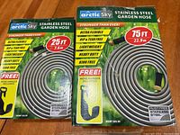 Photo showing two boxes of Arctic Sky stainless steel garden hoses, 25 ft and 75 ft lengths.