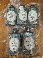 Five unopened bottles of 200g UV Resin Hard resin with botanical label, shrink-wrapped in clear plastic.