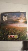 Front cover of the 1998 Canadian Stamp Collection showing a field with sunrise or sunset and preview stamps at the bottom