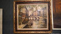 Full frontal view of original Italian oil painting showing canal scene and decorative carved frame.