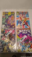 Four Marvel comic books including The Terminator, X-Men, Terror Inc., and Marvel Age inside protective sleeves.