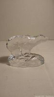 Photo of the solid clear glass polar bear figurine showing full front and side profile on a neutral background.