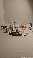 Various animal and object figurines arranged in a group showing overall lot.
