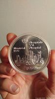 Obverse side showing Montreal city skyline, Olympic rings, date 1976, and denomination 10 Dollars