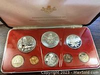 Full view of 1972 Cayman Islands Proof Set in original red velvet case showing 8 coins including 4 large silver coins and smaller denominations