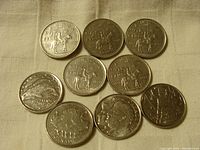 Overview of all coins showing five 1973 Mountie quarters and four additional Canadian coins with various designs.