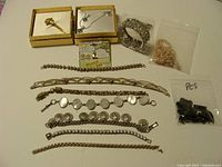 Overview of various jewelry items laid out including bracelets, necklaces, pins, and beads