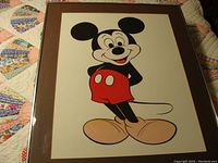 Full view of framed Mickey Mouse lithograph on a quilted background