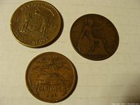 Top view of the obverse and reverse of the Newfoundland 3 Cent 1917, 1919 UK Penny, and 1946 20 Centavos coins showing details of design and condition.