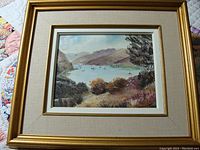Full view of framed oil painting showing Loch Lomond with sailboats and landscape.