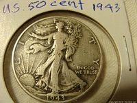 Obverse side of the 1943 US Walking Liberty half dollar coin showing Lady Liberty walking with sun rays and date 1943
