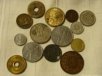 Full view of all 13 mixed world coins showing various designs and metals