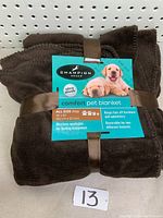 Front view of the folded folded brown Champion Breed pet blanket showing product label with breed photo, size, features such as ultra plush, machine washable, reversible textures