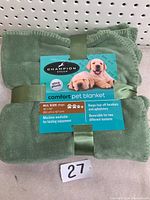 Green Champion Breed pet blanket folded with label showing size and features
