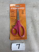 Photo of Fiskars scissors with standard straight blade, pink handle, in original packaging with orange backing