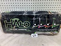 Photo of the damaged box showing 'HALO Ride Alive' branding, neon green accents, and illustrations of the scooter.