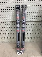 Two rolls of Private Eyes Premium Superior window tint standing vertically against a pegboard.