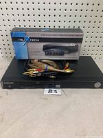 Samsung DVD player with Nexxtech box and cables on top