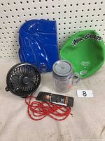 Photo showing the entire lot including green MacGregor inflatable dodgeball, blue air pillow, USB clip-on fan, clear Allison water bottle, and red show laces.