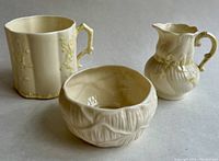 Three-piece set showing mug, creamer, and sugar bowl from front angle on white background