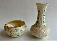 Front view showing both bud vase and sugar bowl with green shamrock motif on cream porcelain with basketweave pattern on bowl