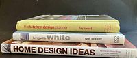 Stacked view of three decorating books showing titles and authors on spines and covers