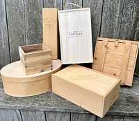 Photo showing six assorted wooden boxes and crates arranged on a wooden surface