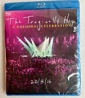 Front cover of The Tragically Hip Blu-Ray disc showing concert scene with stage lights and crowds, titled 'A National Celebration' with date 20/8/16.